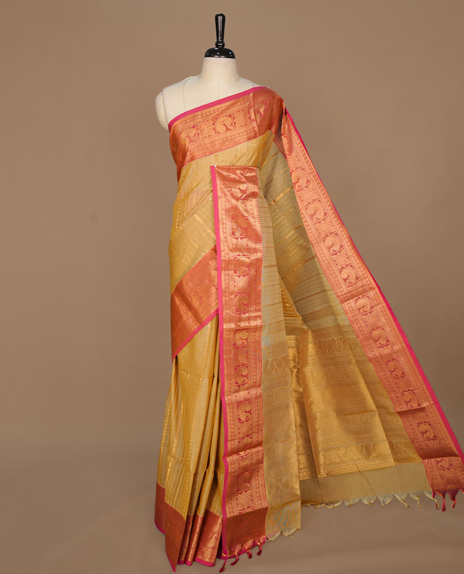 Beige colour chettinad saree featuring gold zari stripes on body, complemented by contrast Magenta colour with traditional border, paired with matching blouse piece.