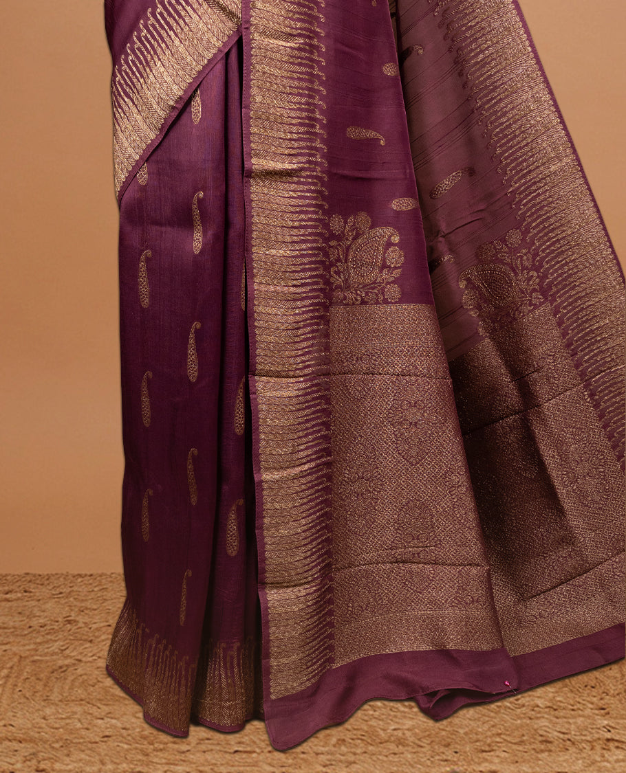 Burgundy colour Semi Banaras Tussar Georgette Featuring Gold zari Leaf pattern on body, Finished with Gold zari border and paired with matching blouse piece.