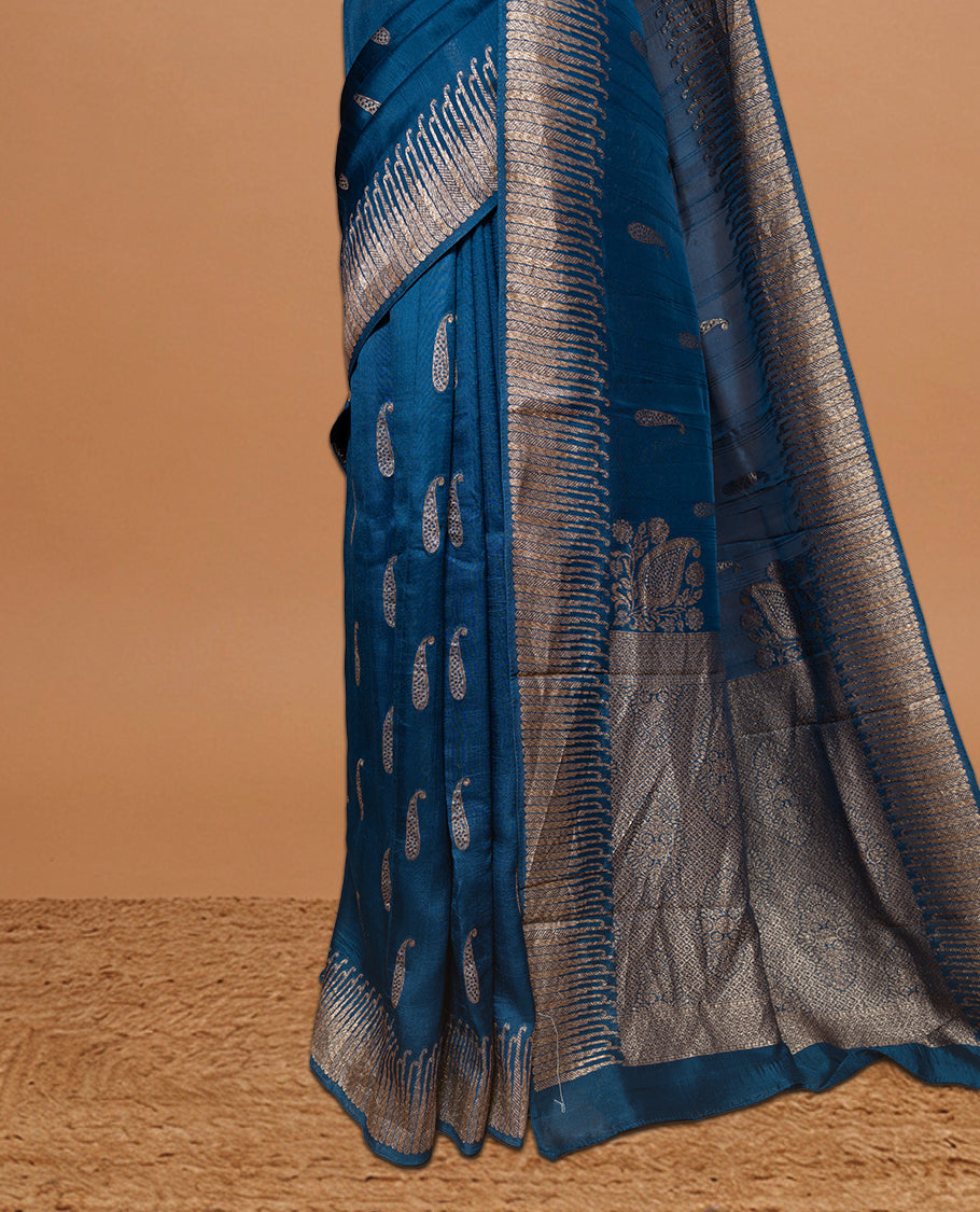 Blue colour Semi Banaras Tussar Georgette Featuring Gold zari Leaf pattern on body, Finished with Gold zari border and paired with matching blouse piece.