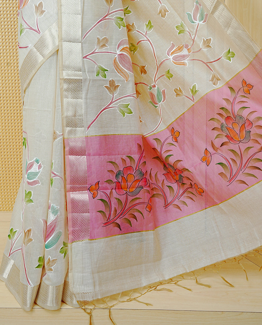 Cream Colour Tissue Kerala Saree Featuring Floral Kodi Threadwork Across The Body, Enhanced With A Light Gold Zari Border And A Pink Floral Pallu, Finished With Gold Tassels And A Matching Blouse Piece