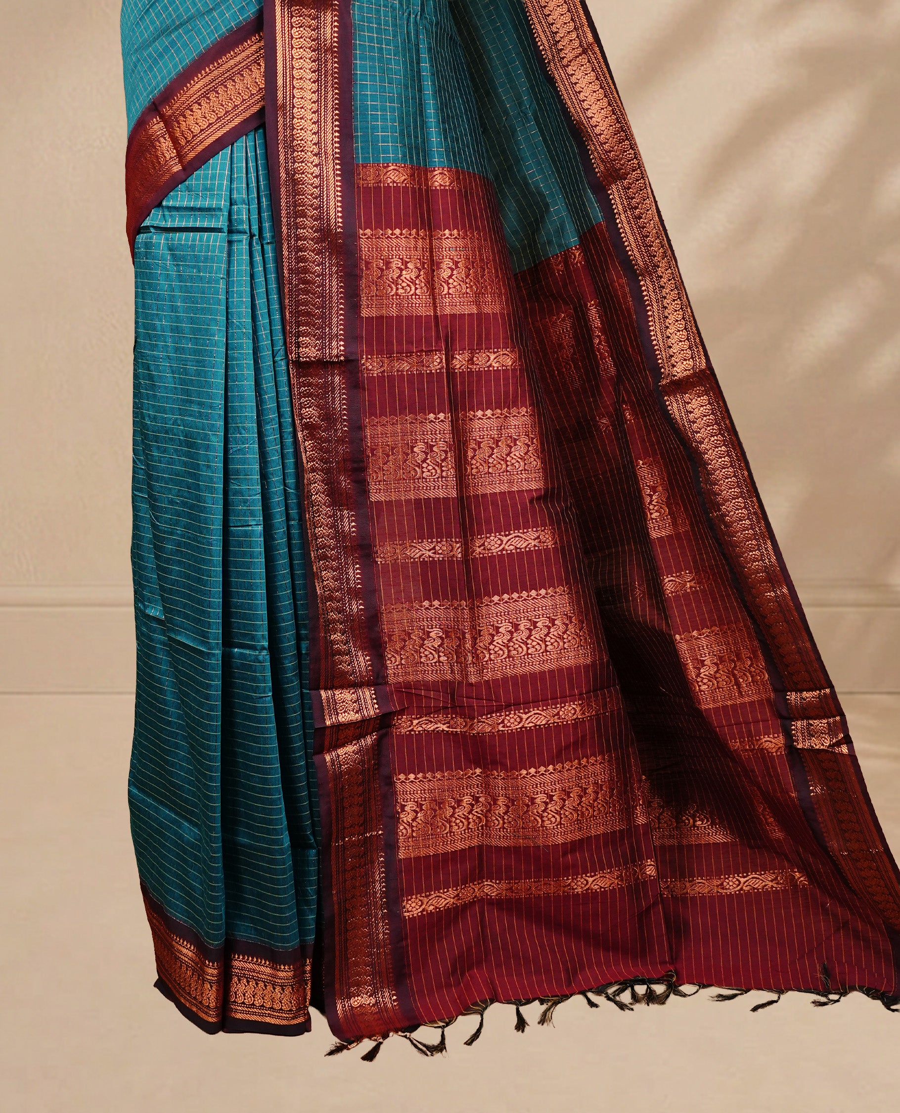 Blue colour kalyani cotton saree featuring antique zari motifs on body, complemented by Maroon colour with Antique zari border, paired with matching blouse piece.