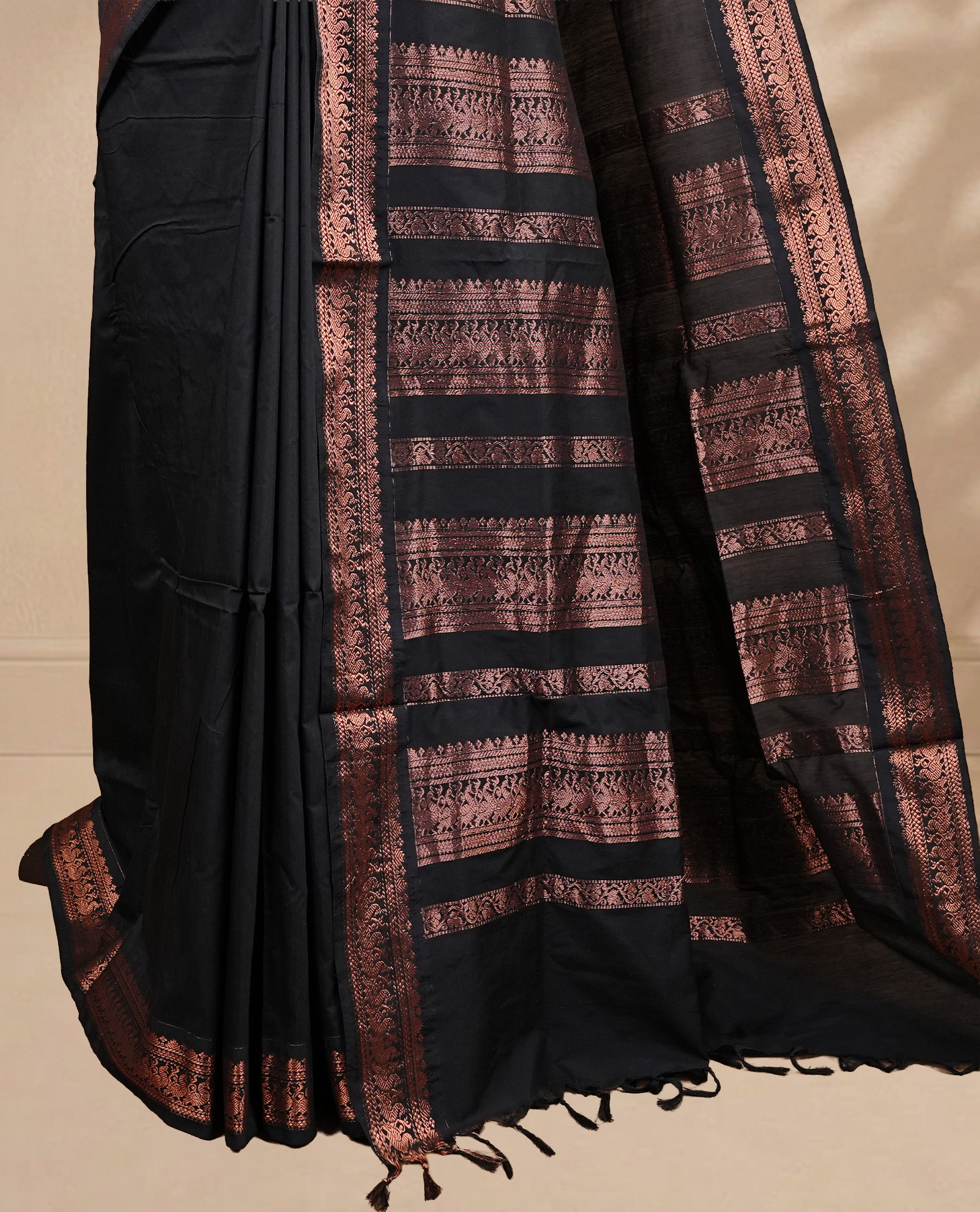 Black colour kalyani cotton saree featuring elegant plain body, complemented by self colour with Antique zari border, paired with matching blouse piece.