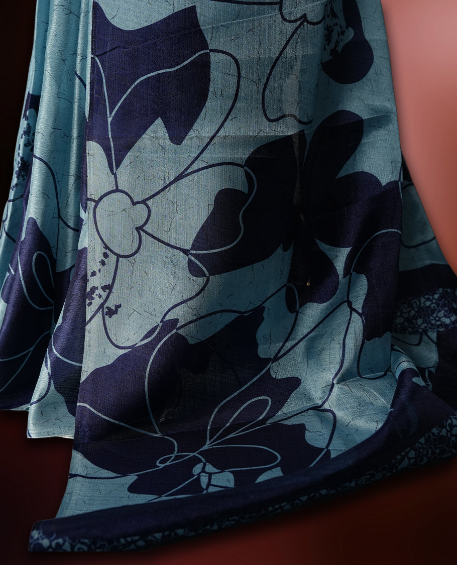 Sky blue colour saree with bold navy floral prints across the body and pallu.,Crafted in soft, lightweight fabric for an elegant drape, Paired with matching blouse.