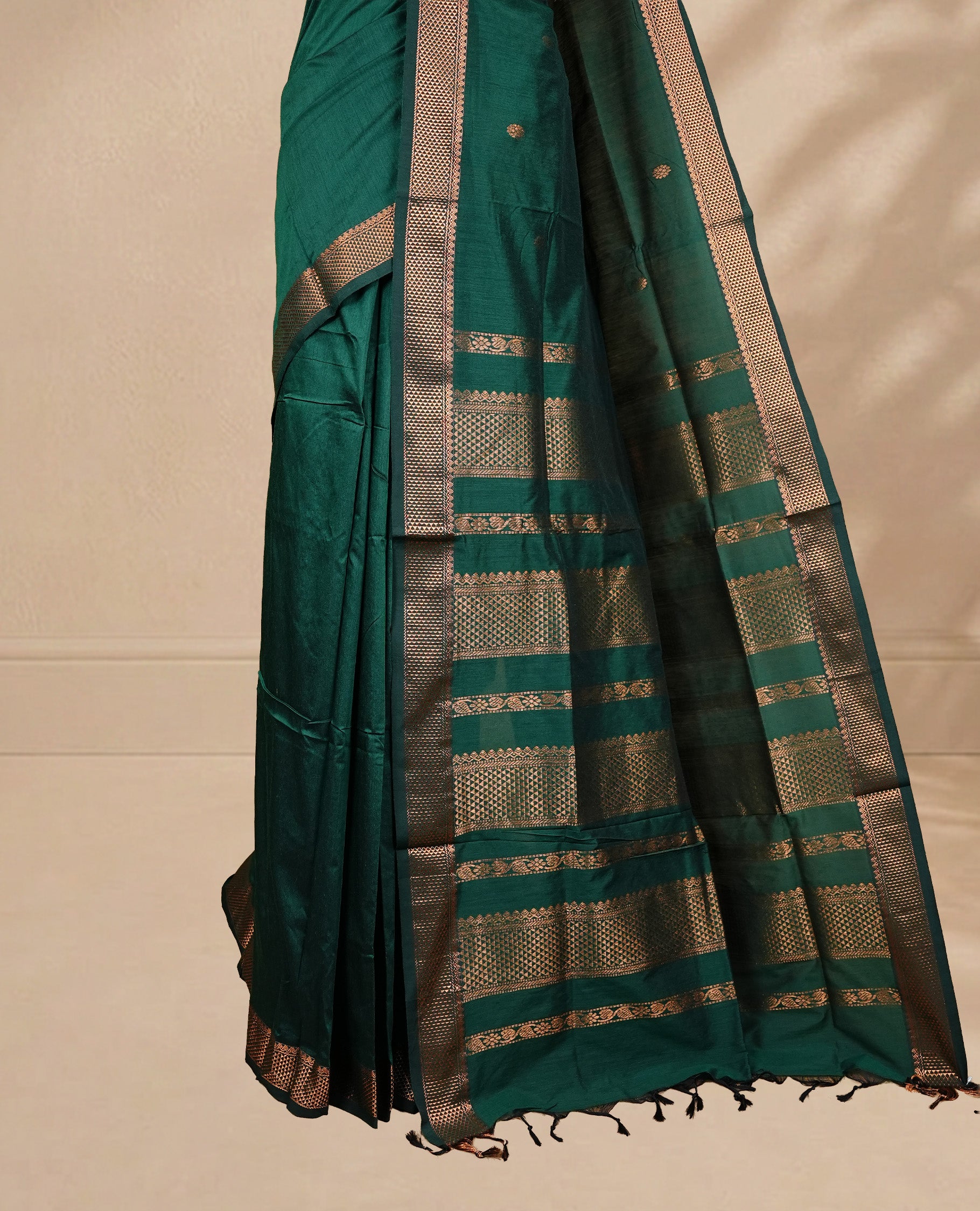 Green colour kalyani cotton saree featuring antique zari motifs on body, complemented by Self colour with Antique zari border, paired with matching blouse piece.