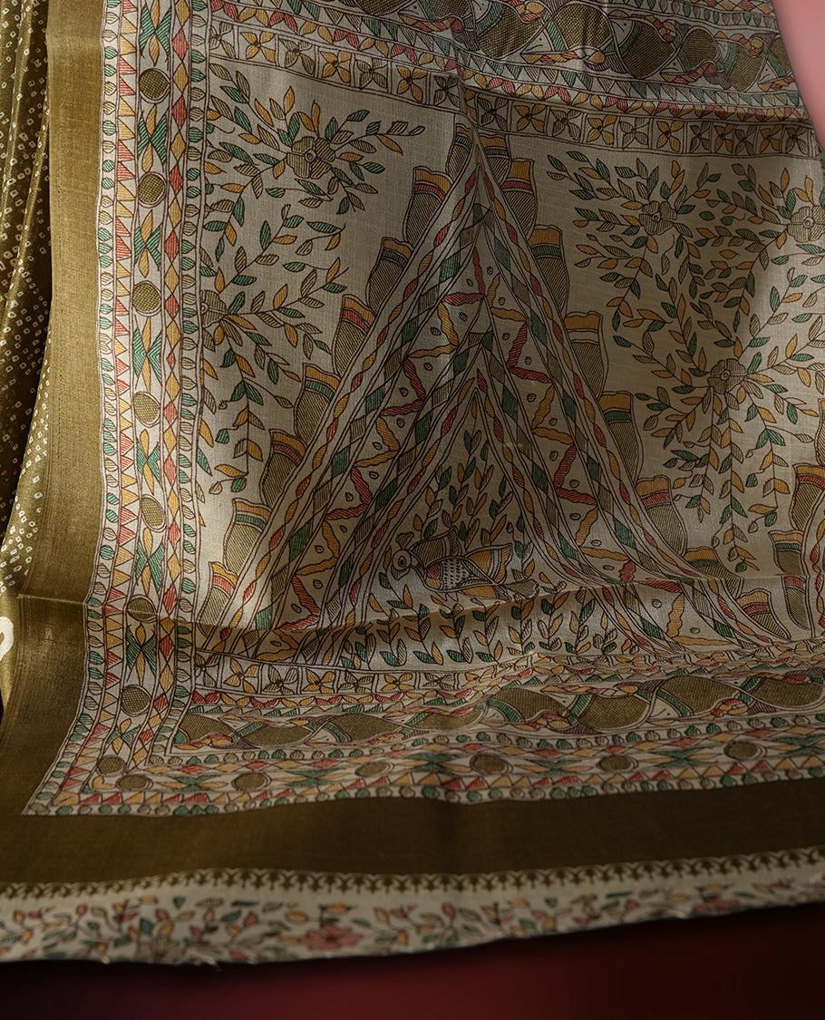 Golden brown colour saree with dotted tie dye patterns and cream circular border motifs & The pallu features exquisite Madhubani inspired designs in earthy hues,Paired with matching blouse, ideal for festive wear.