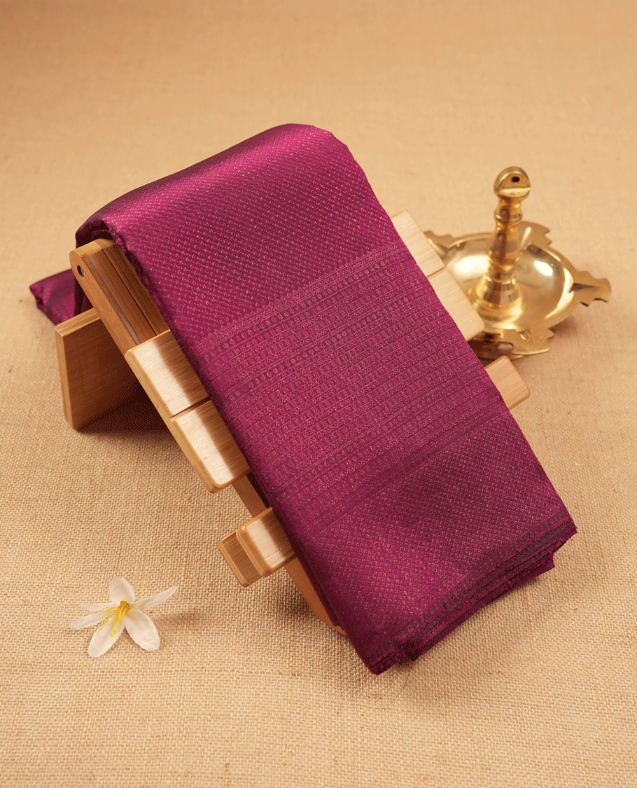 Cranberry coloured Manthrakodi saree featuring a multicoloured zari jacquard body, complemented by a self coloured turning Banarasi border and a matching self coloured blouse.