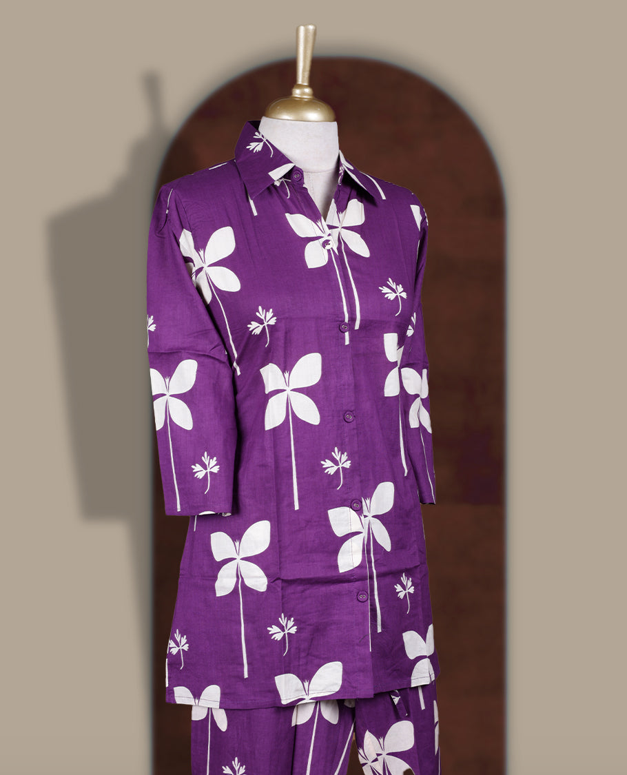 Dark purple colour cord set with bold off white floral prints,Features a collared kurta with front buttons and 3/4 sleeves, paired with matching pants for a trendy and contemporary ethnic look.