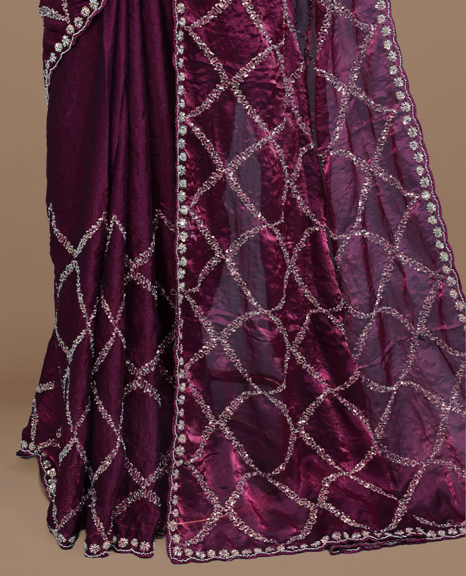Burgundy colour designer saree featuring Sequins & cut beats worked body, cut beat worked border, paired with matching unstitched blouse.