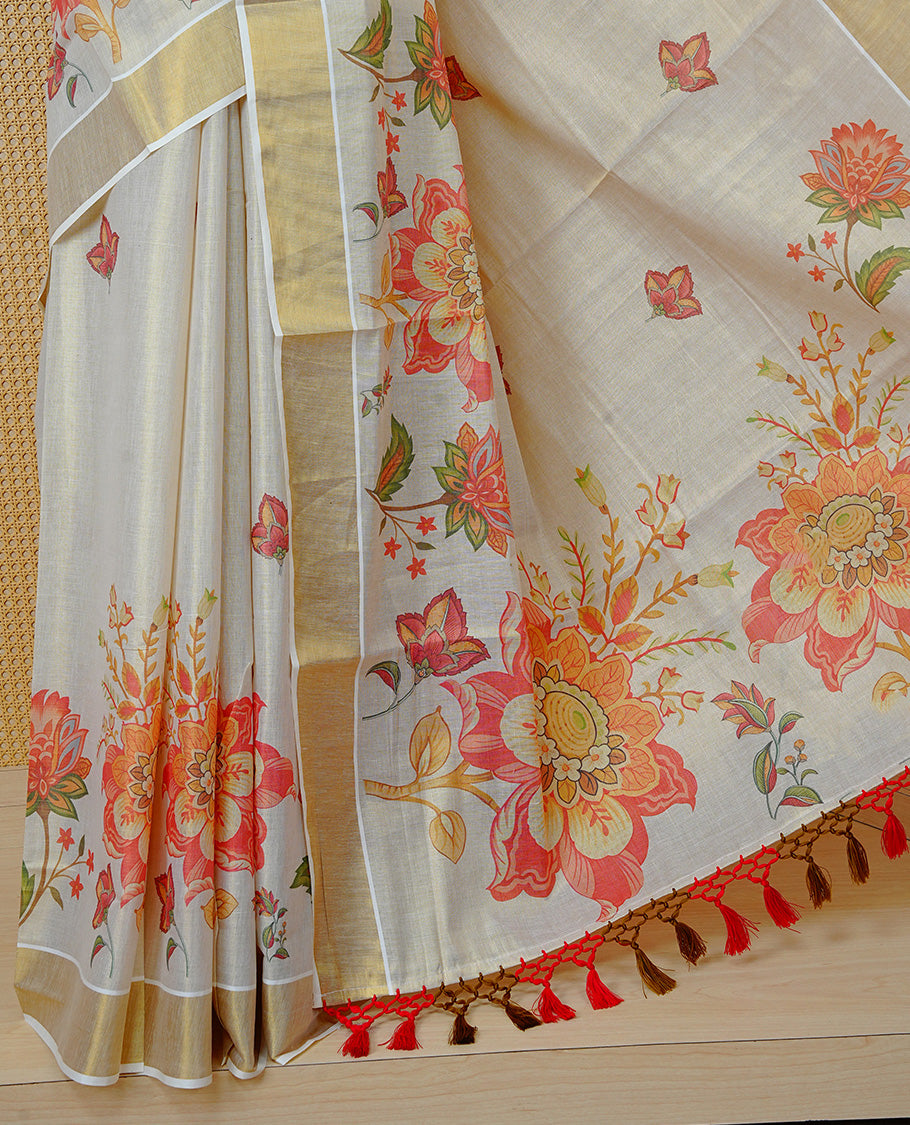 Cream Colour Tissue Kerala Saree Featuring A Digital Floral Printed Body & Pallu, , Beautifully Enhanced With A Classic Gold Zari Border And Red & Olive Green Tassels, Paired With A Matching Blouse Piece.