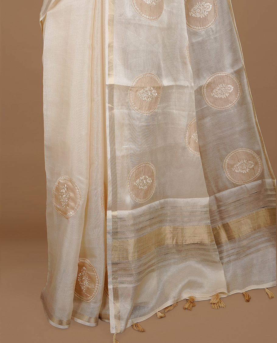 Cream colour Tussar saree featuring gold colour circle pattern with chikankari embroidery work, highlighting gold zari simple border, paired with matching unstitched blouse.