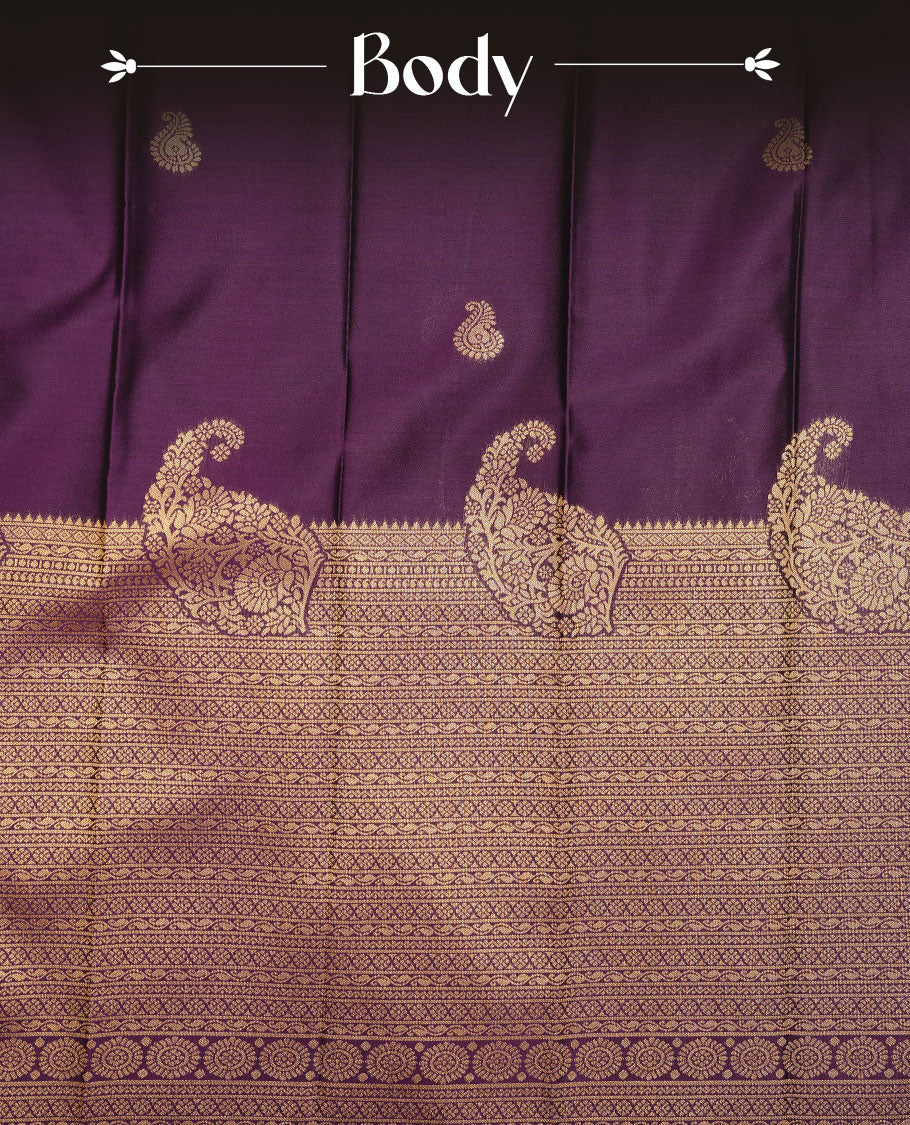 Purple colour soft silk sareee featuring rose gold zari motifs on body, complemented by self colour with zari border, contrast green pallu paired with matching blouse piece.