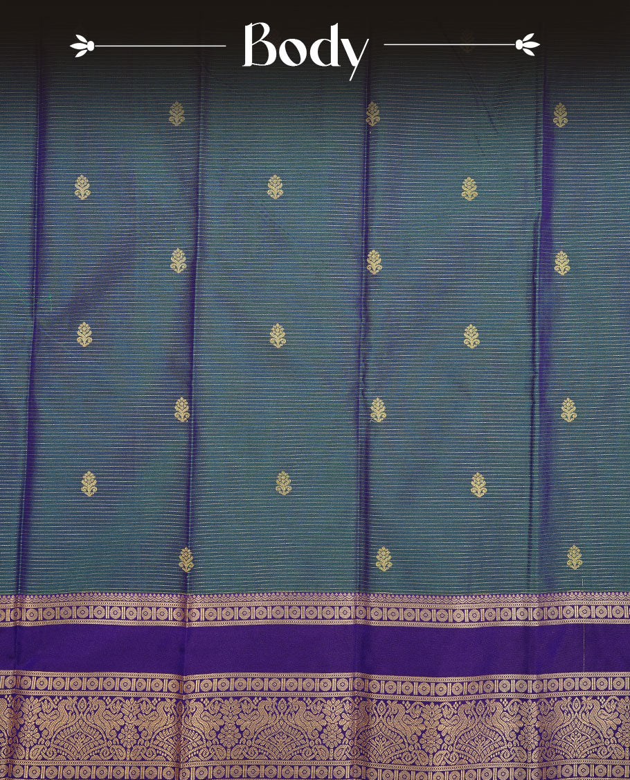Teal colour soft silk saree featuring Gold zari Check & motifs on body, complemented by contrast indigo colour with traditional border, paired with matching blouse piece.