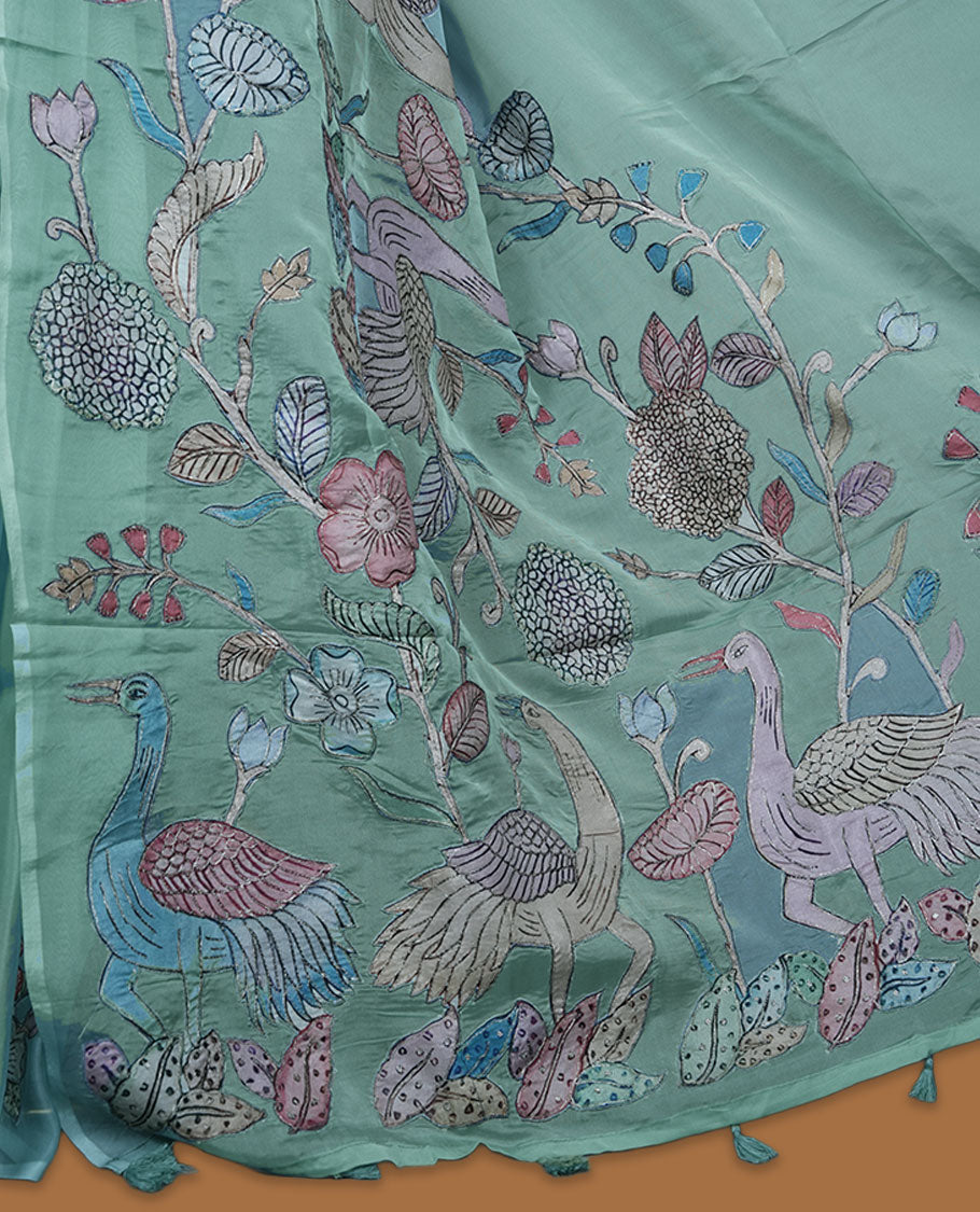 Mint green colour organza saree with multicolour thread embroidery on the pallu and fine border detailing, paired with a matching blouse.