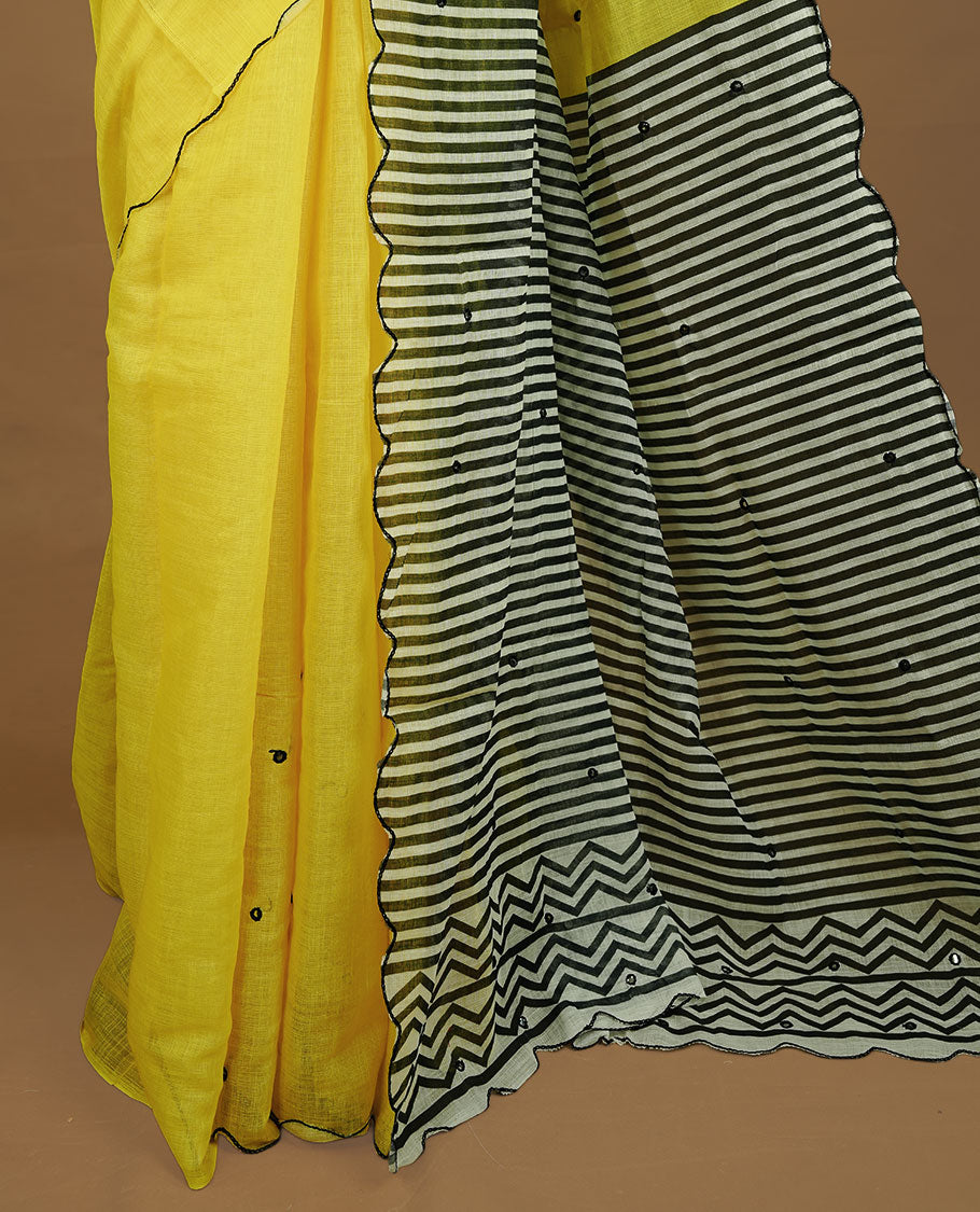Yellow colour Semi Linen saree featuring mirror work with intricate thread detailing, enhanced by a stylish scallop border. Comes without a blouse piece.
