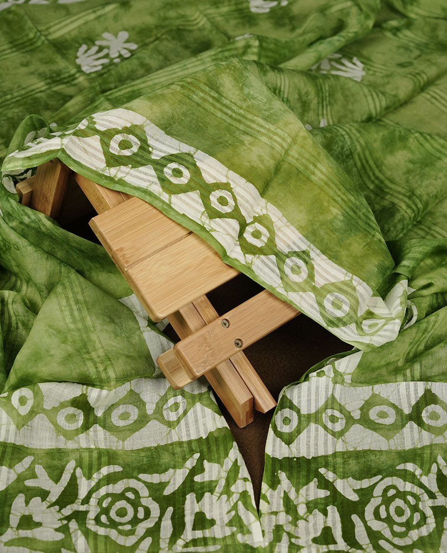 Green colour churidar material featuring white floral printed body, paired with a matching chevron printed dupatta.
