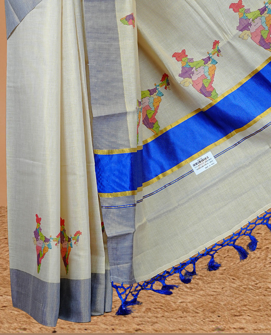 Cream Colour Kerala Saree Featuring Plain Body ,Complemented By A Blue Zari With Indian Map Border ,Enhance By A Gold Zari & Blue Pallu ,Paired With A Matching Blouse Piece.