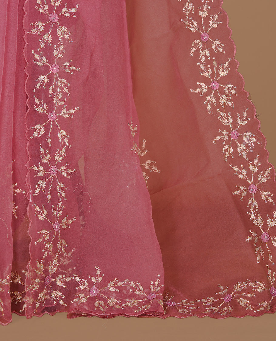 Mauve colour crush organza saree featuring gold threan floral and stone worked body, highlighting scalp designed border, paired with matching blouse piece.