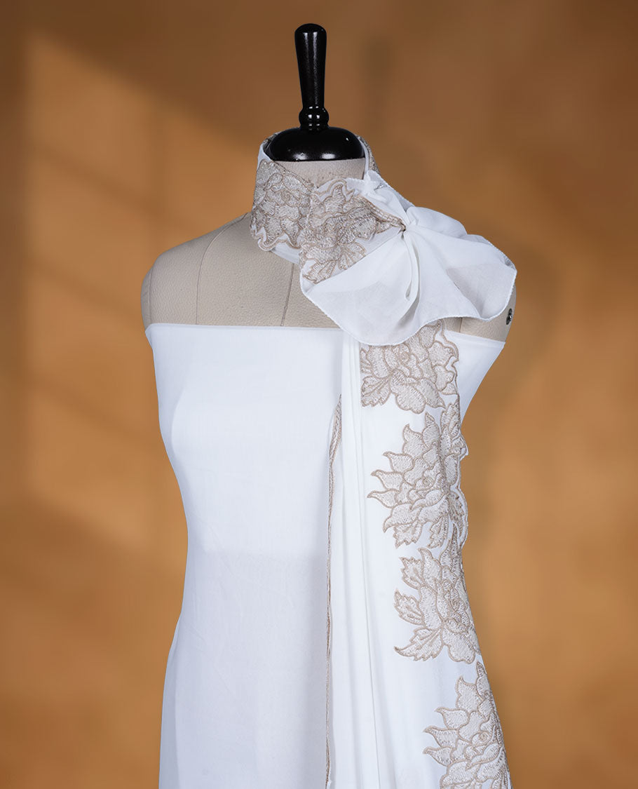 Off White colour georgette salwar material with elegant thread work on the body, paired with a flowy dupatta featuring delicate detailing, and complemented by a plain bottom for a graceful finish.