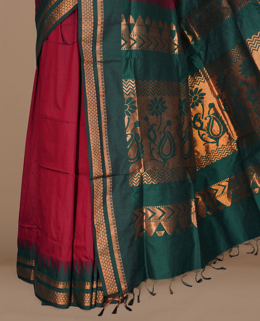 Maroon colour kalyani cotton saree featuring gold zari motifs on body, complemented by contrast maroon color with gold zari pattern border , paired with matching blouse piece.