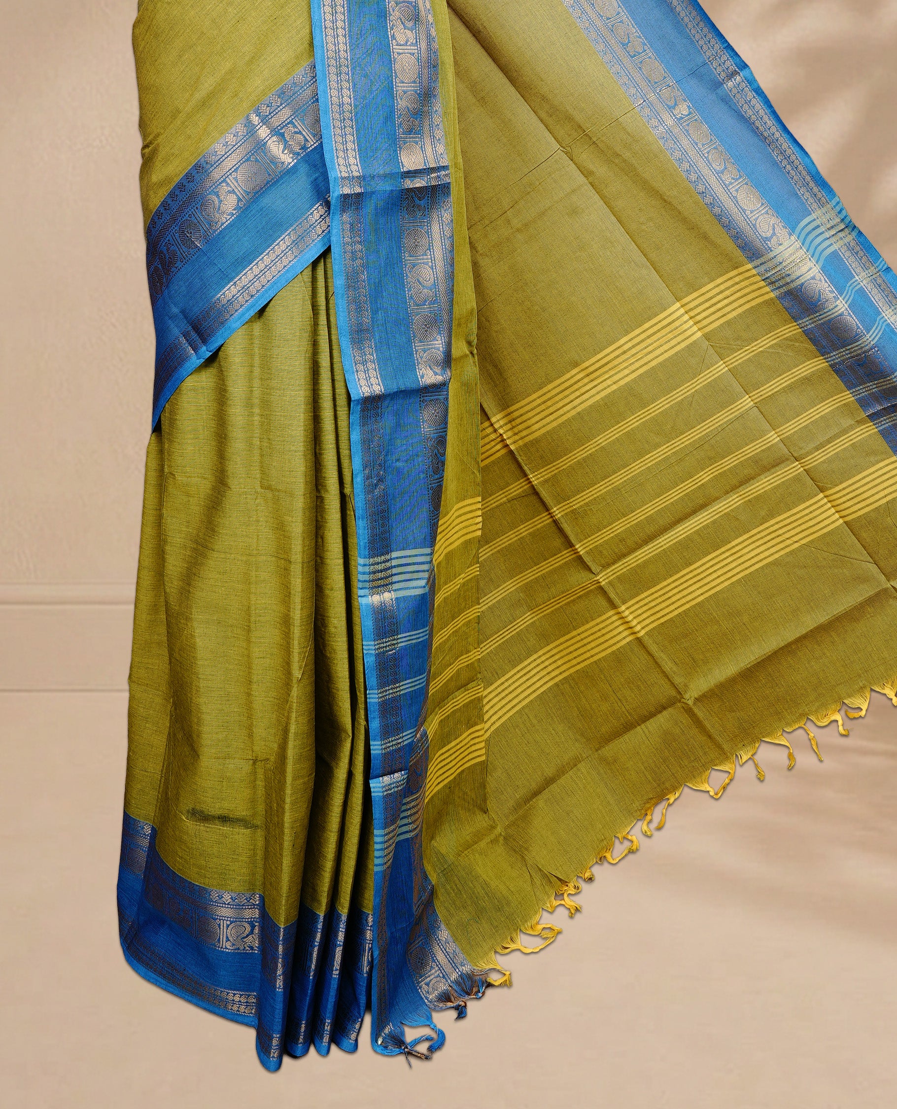 Olive colour Chettinad cotton saree featuring Elegant body, complemented by Contrast Blue colour with Gold zari border, paired with matching blouse piece.