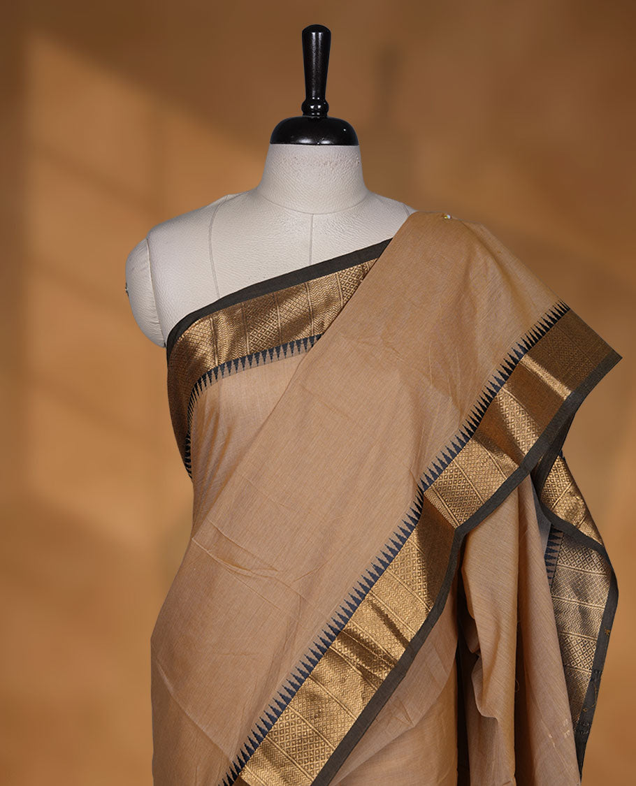 Sandal colour chettinad cotton saree featuring Elegant plain body, contrast Black colour border with gold zari temple border, pallu and paired with matching blouse
