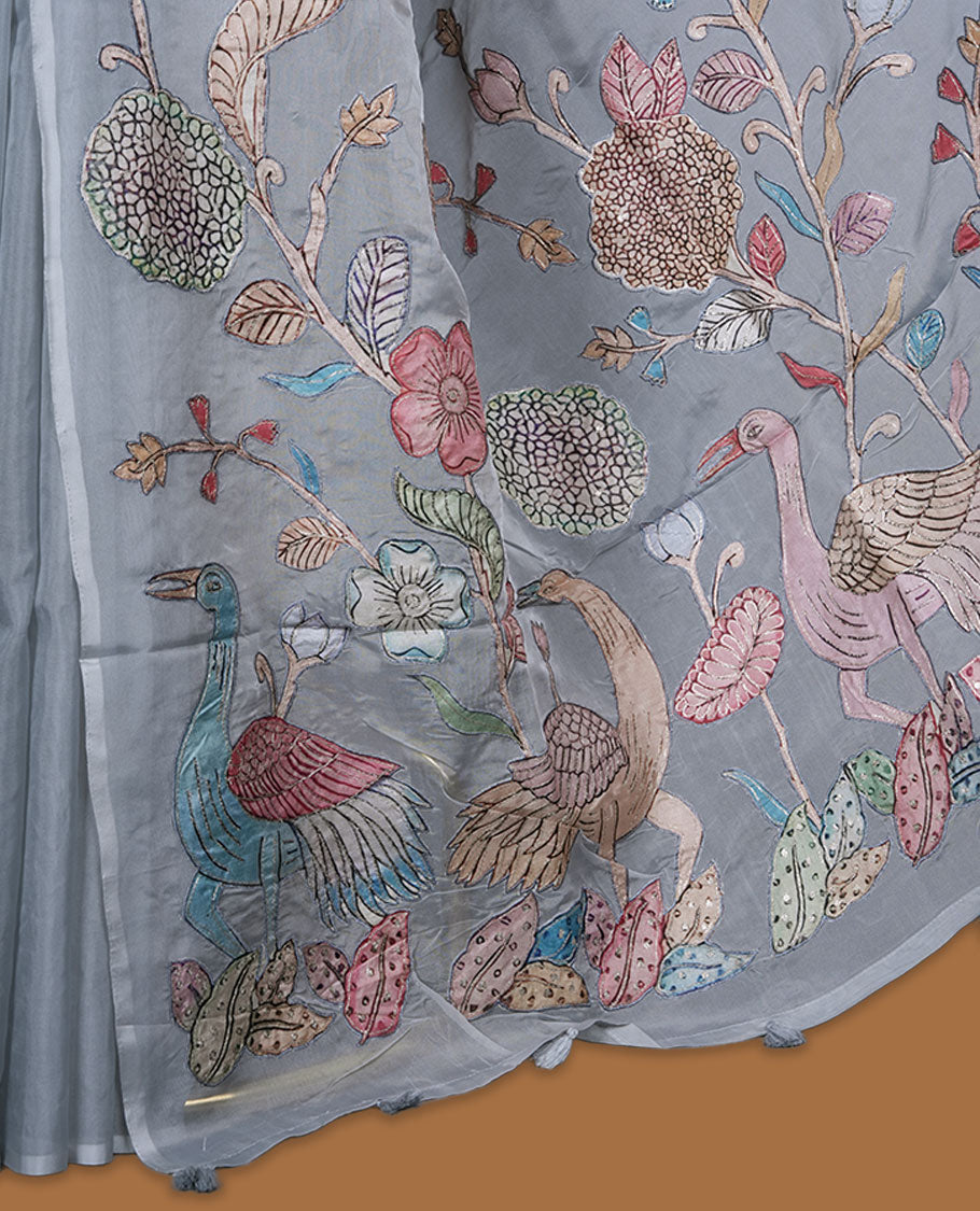 Grey colour organza saree featuring multicolour floral and bird printed motifs on the pallu with a subtle fine border, paired with a matching printed blouse.