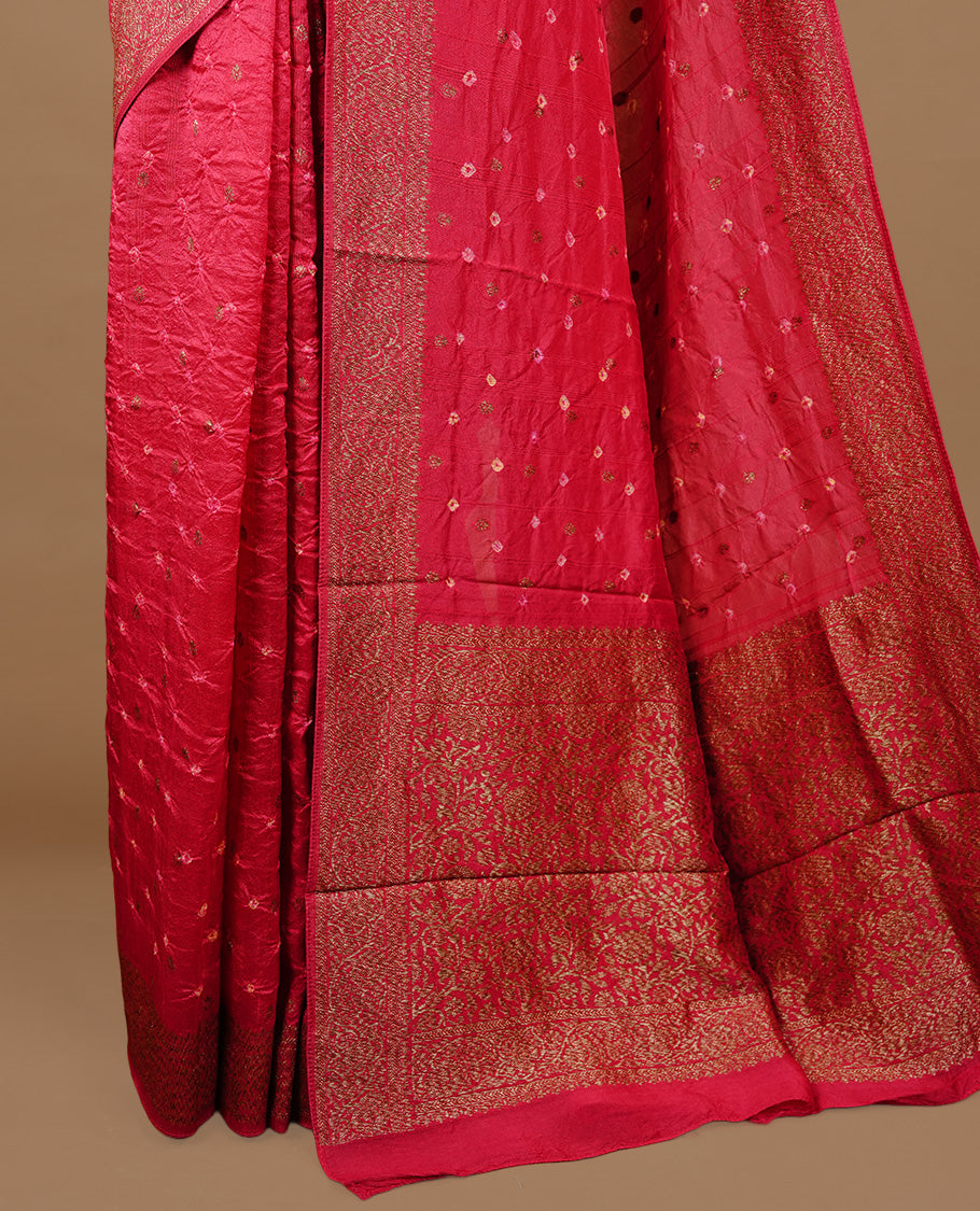 Red colour Banarasi Bandhani silk saree featuring intricate antique zari circle Buttas across the body, complemented by an elegant antique zari border. Comes paired with a matching blouse piece