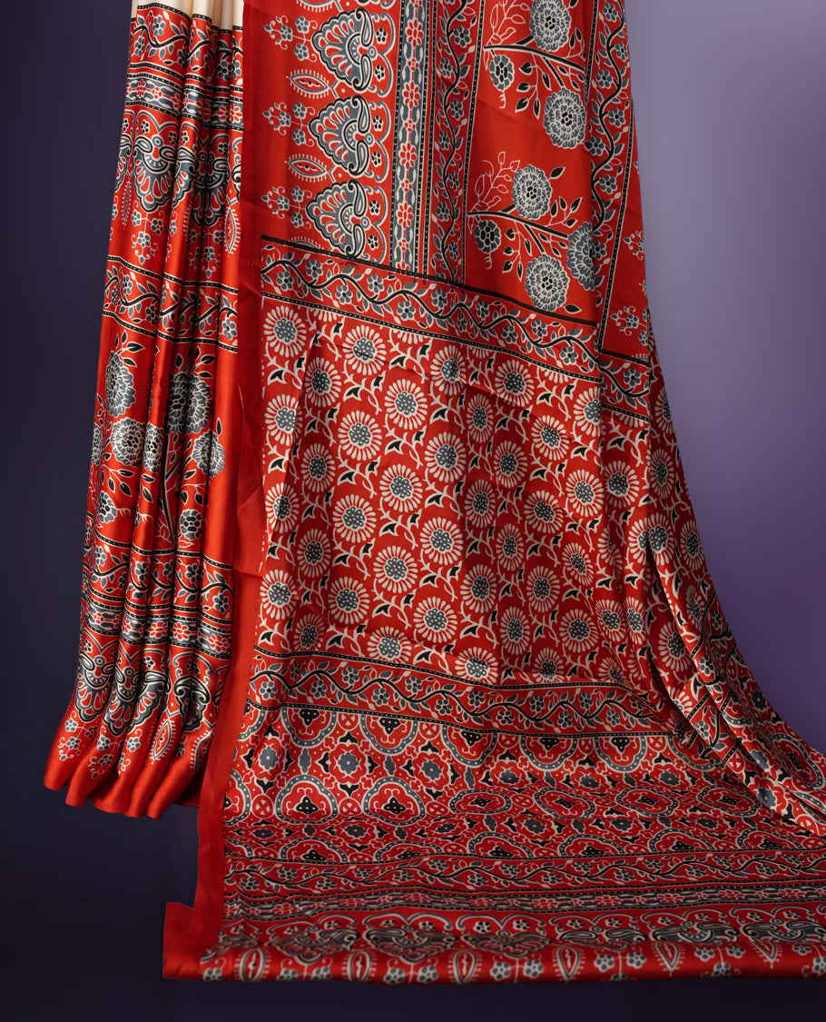 Cream colour saree enhanced with a vibrant red border and pallu, adorned with intricate blue and grey traditional motifs, comes with a matching blouse.