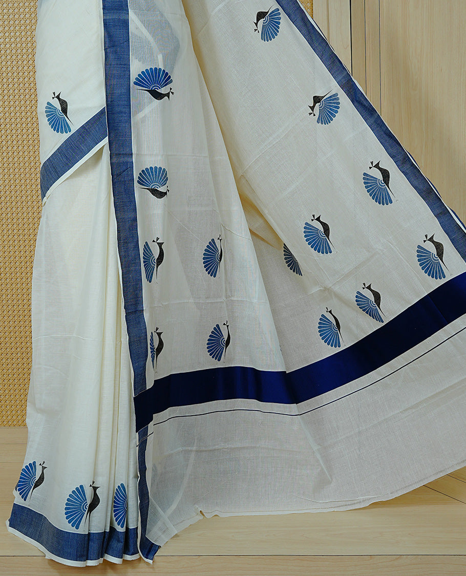 Cream colour Cotton Kerala saree Featuring Classy Plain body for Effortless Elegance, enhancing Navy blue with Peacock Printed border, paired with matching blouse piece.