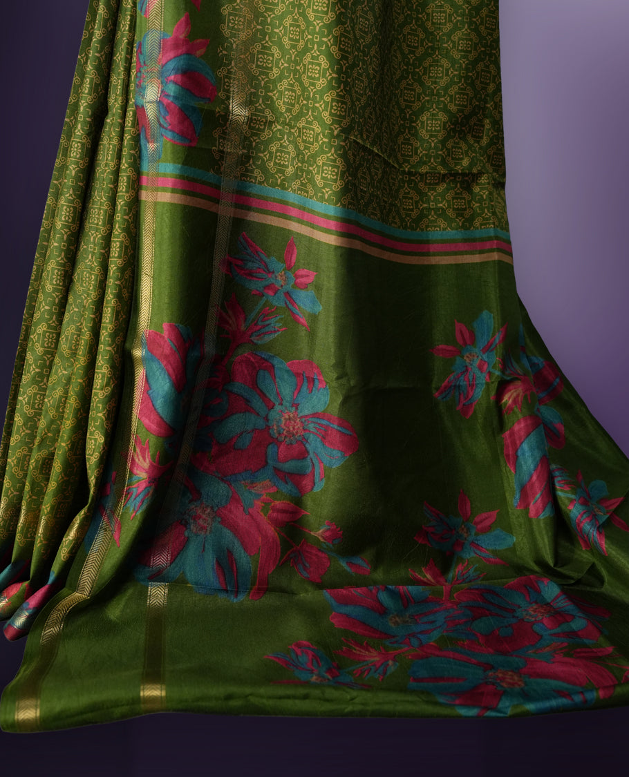 Green colour saree enhanced with a vibrant golden border and floral print pallu, adorned with intricate teal and pink floral prints on the body & comes with a matching blouse.