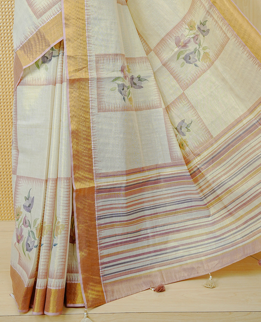 Cream Colour Tissue Kerala Saree Featuring Floral Prints in a Stylish Rectangle Pattern On Body, Enhanced with a Gold Zari Border and a Multicoloured Striped Pallu. Finished with Elegant Tassels and Paired with a Matching Blouse Piece.