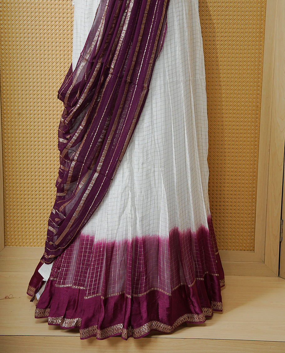 Off white colour Semi stitched dhavani set featuring Gold zari check pattern with contrast Purple border skirt, paired with matching blouse & dupatta.