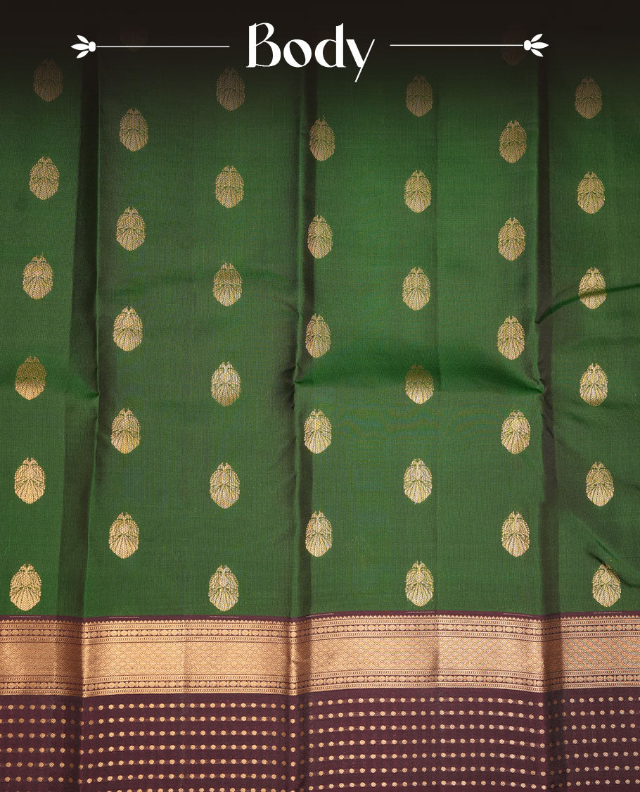 Green colour Vasundhara silk saree featuring gold zari buttas on body, complemented by contrast burgundy colour zari border, paired with matching blouse piece.