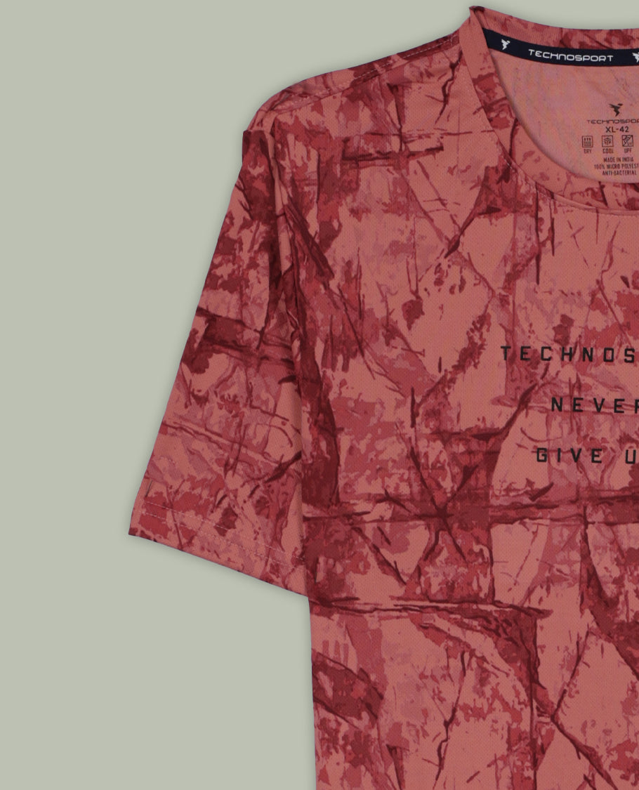 Light coral colour T shirt featuring a bold abstract tie dye pattern in darker red tones, designed with a classic round neck and short sleeves for a relaxed and stylish everyday look.