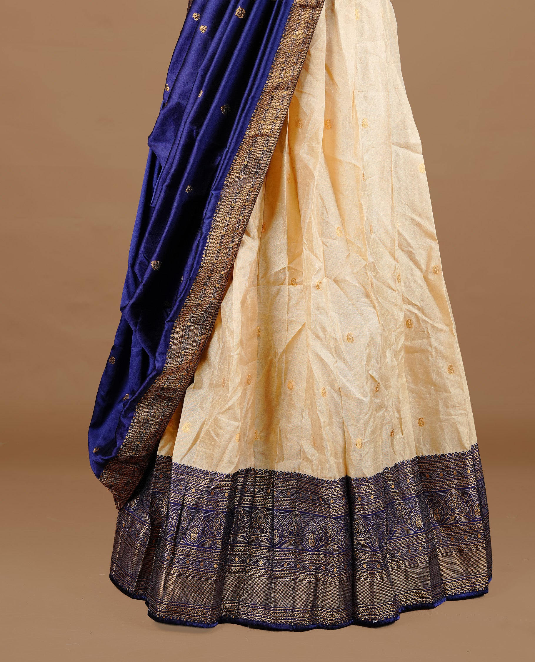 Gold and blue colour Half saree featuring gold colour skirt with contrast blue colour border with gold zari pattern, paired with matching dupatta and stitched blouse piece.