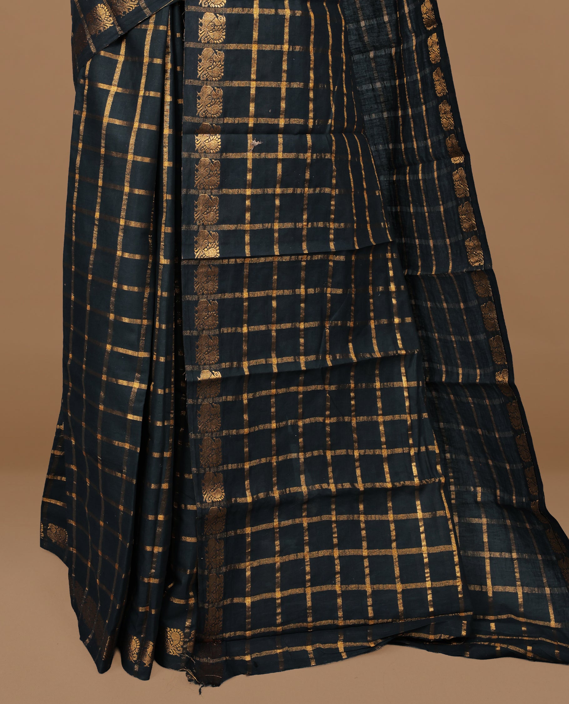Black colour Sungudi cotton saree featuring Gold zari Check pattern on body, Gold zari Peacock design on Self colour border, paired with matching blouse piece.