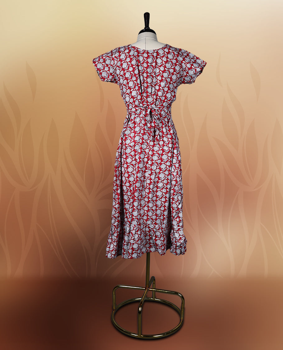 Red colour nightwear with a charming white floral print, featuring a V neckline, flutter sleeves, and a flared ruffle hem, A perfect pick for casual days, summer outings, or light festive wear.