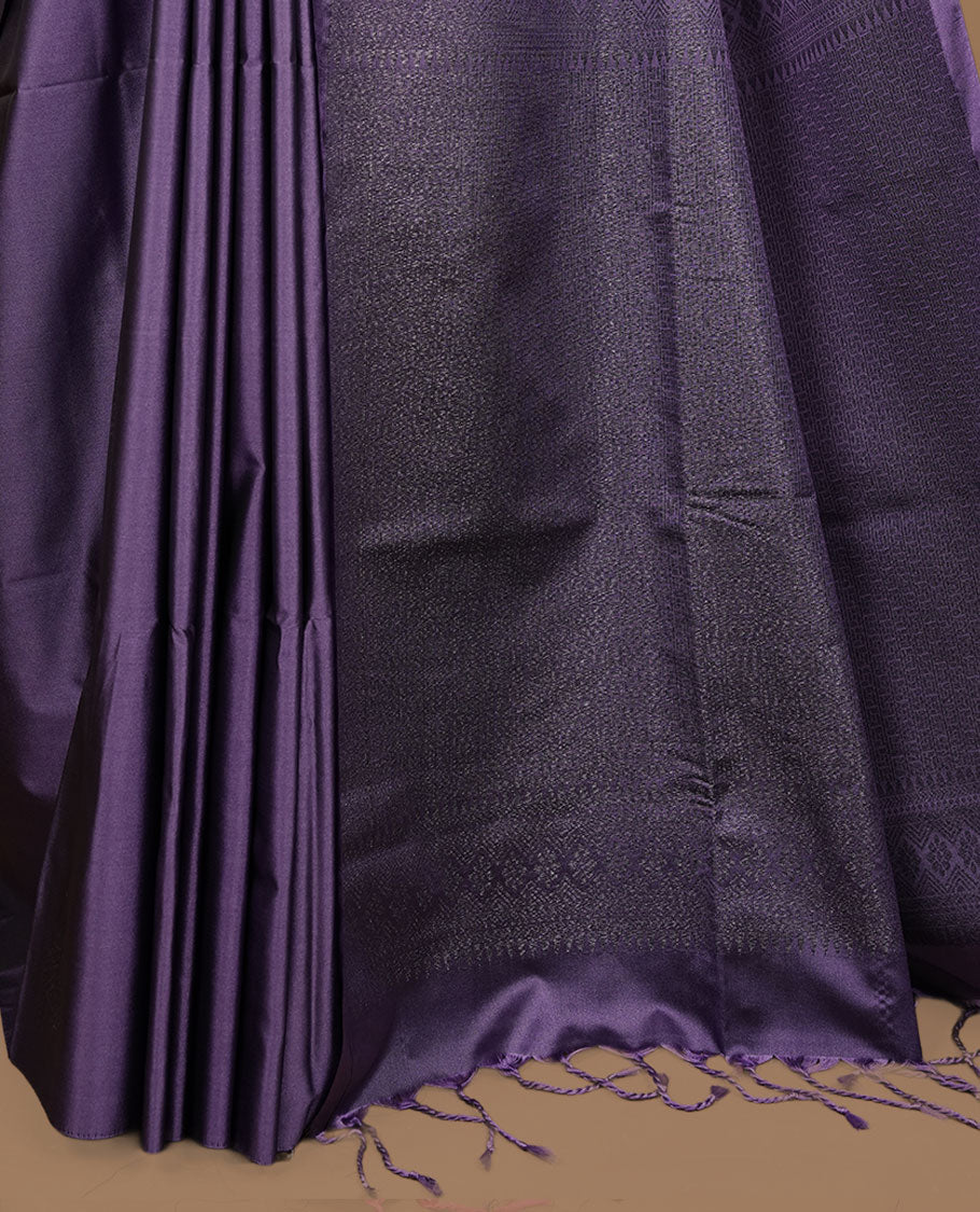 Lavender soft silk saree features a sleek borderless design with intricate antique zari motifs, flowing into a seamless self colored pallu and a matching blouse piece.