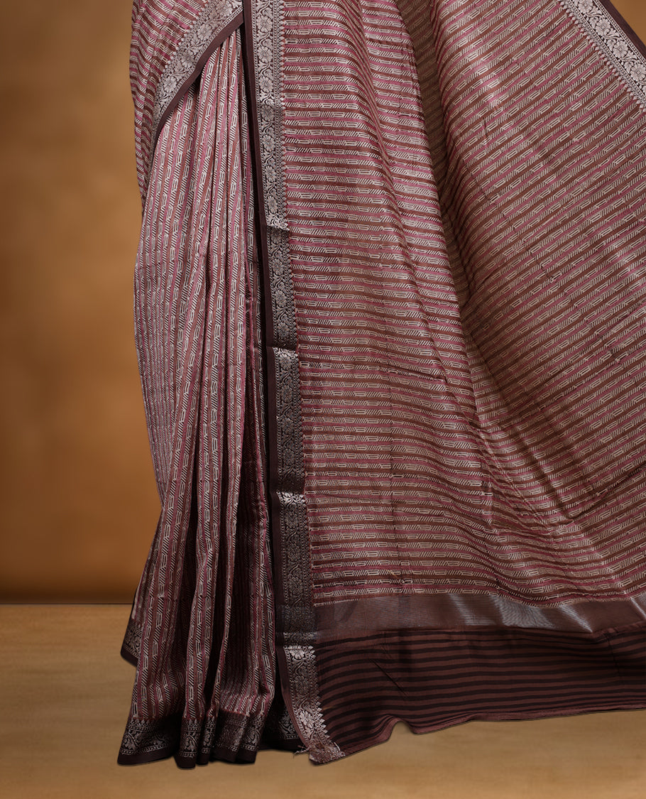 Cream colour chanderi silk saree with Brown& pink geometric stripped printed On body, compilmented by contrast chocolate brown colour border with golden zari floral pattern and a matching blouse.
