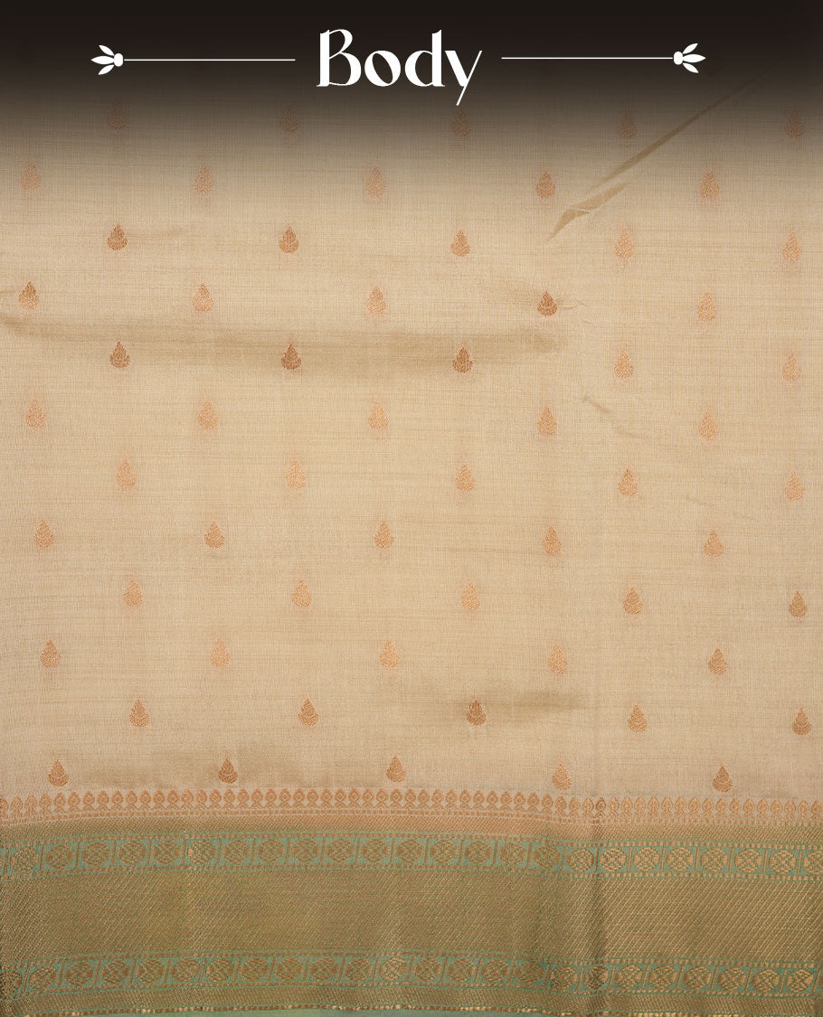 White gold colour semi tussar saree featuring Gold zari buttas body, contrast Ice blue colour gold zari border and comes with matching blouse piece.