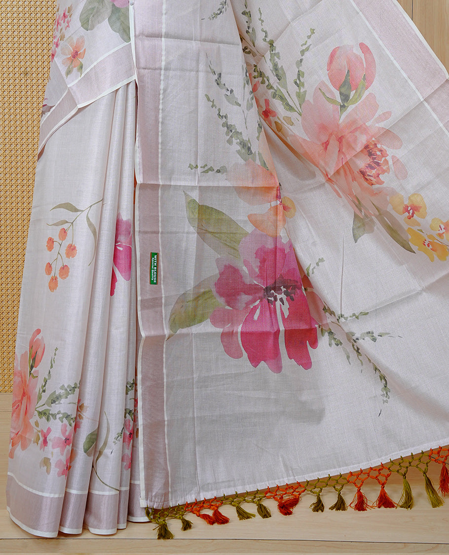 Cream Colour Tissue Kerala Saree Featuring A Digital Floral Printed Body & Pallu , Beautifully Enhanced With A Classic Rose Gold Zari Border And Orange & Olive Green Tassels, Paired With A Matching Blouse Piece.