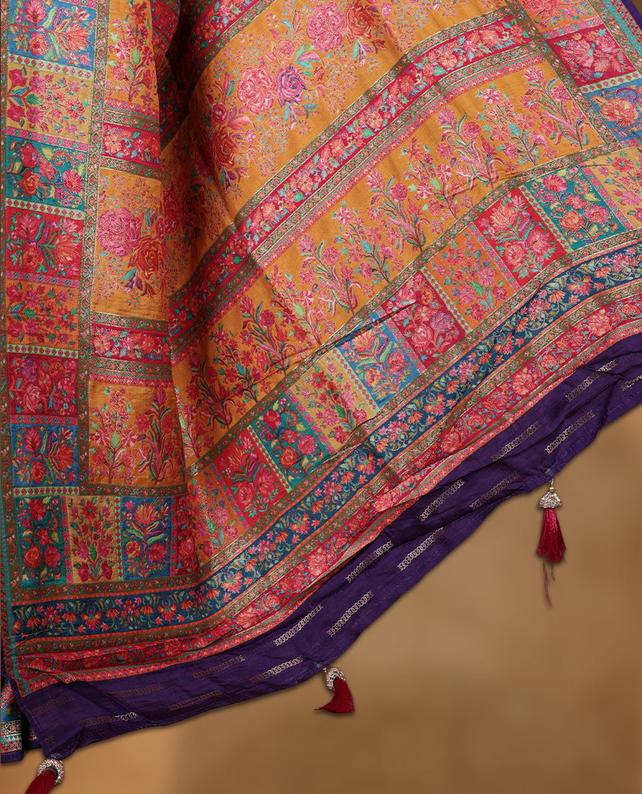 Mustard colour Pashmina silk saree richly woven with vibrant floral jaal across the body, framed by contrast pink and teal panelled zari borders and a grand patterned pallu, paired with a deep purple woven motif blouse piece.