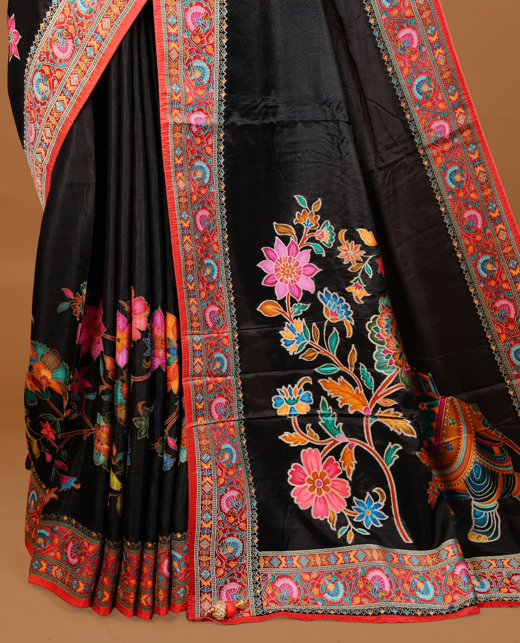 Black colour Pashmina Saree featuring a plain body, a multicolour floral woven border, a floral woven pallu, paired with a matching blouse.