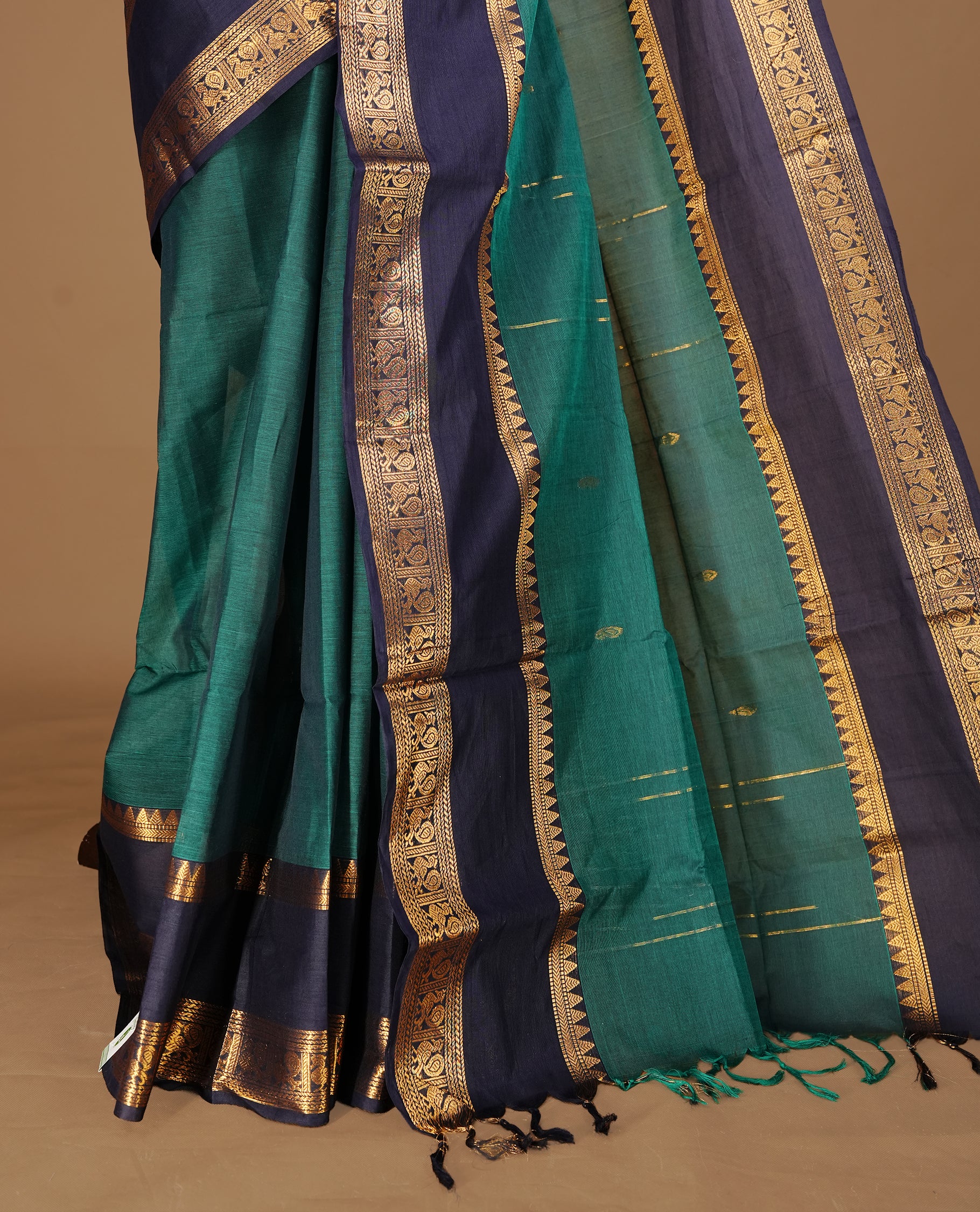 Dark green Colour Chettinad cotton saree featuring Godl zari motifs on body , complemented by contrast blue colour with traditional border, comes with matching blouse piece.
