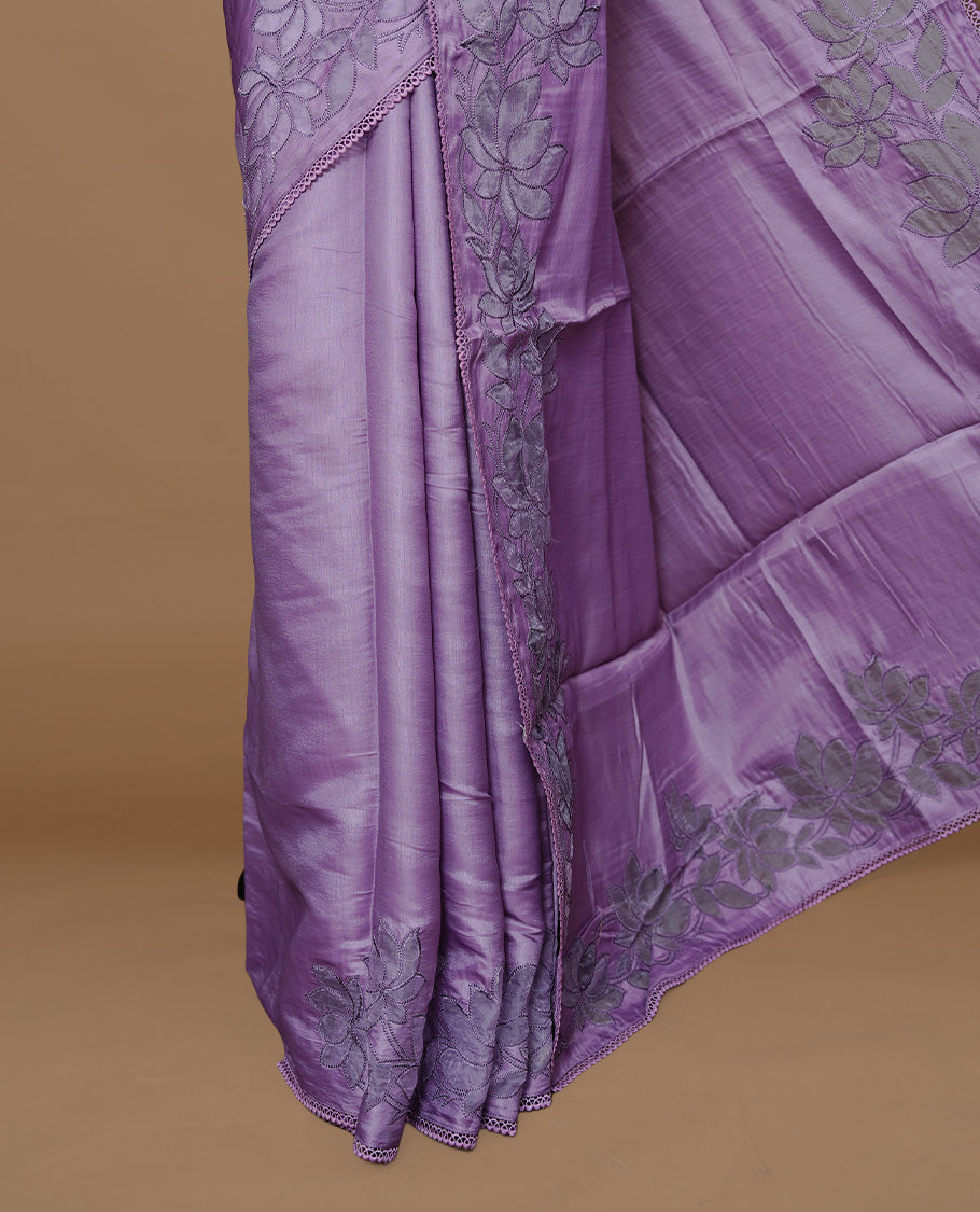 Pastel Purple colour Designer saree Featuring Elegant plain body, enhance with thread Lotus Pattern with lace border, paired with matching blouse piece.