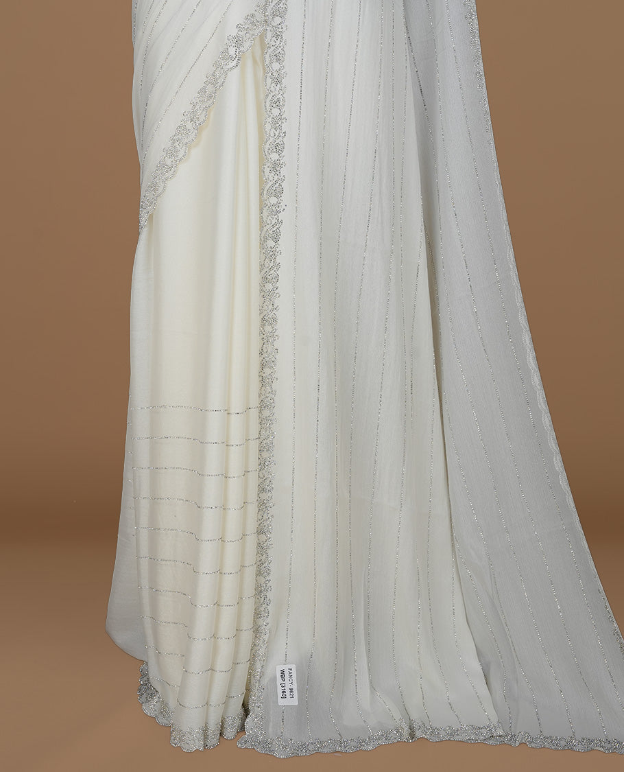 Off white colour designer saree featuring white stone stripes on body, highlighting white stone with scalp border, paired with matching blouse piece.