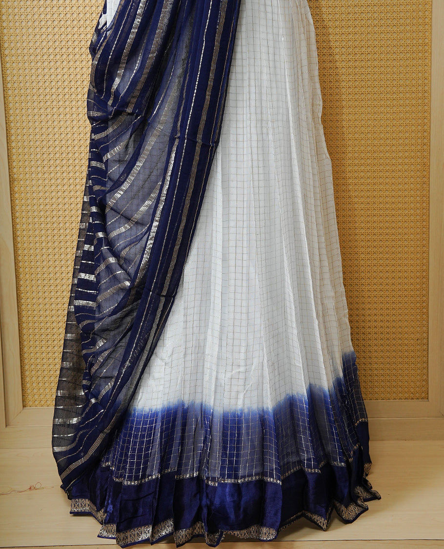 Off white colour Semi stitched dhavani set featuring Gold zari check pattern with contrast Navy blue border skirt, paired with matching blouse & dupatta.