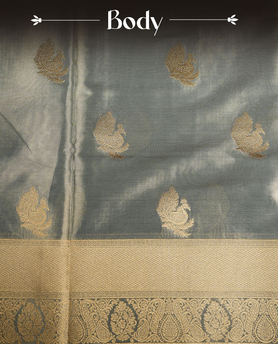 Dual tone light blue and gold colour tissue brocade saree featuring antique gold zari motifs on the body with a rich traditional zari border and pallu, paired with a matching blouse piece.