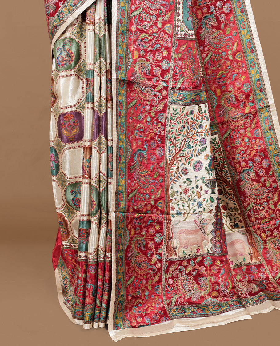 Cream colour Pashmina silk saree features an all over Multi colour box with motifs body, a contrast red peacock border and pallu, and a matching unstitched blouse.
