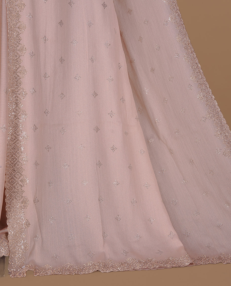 Light peach colour organza designer saree featuring Gold stone motifs on body, highlighting light weight stone worked border, paired with matching blouse piece.